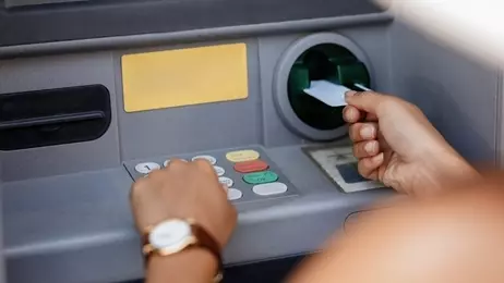 ผู้หญิงกำลังกดเงินจากตู้ ATM