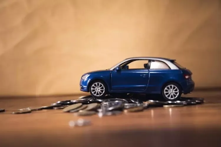 รถของเล่นสีน้ำเงินวางบนกองเหรียญ รถของเล่นสีน้ำเงินวางบนกองเหรียญ